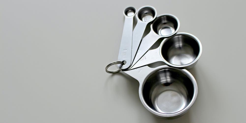 A set of 5 different sized metal measuring cups